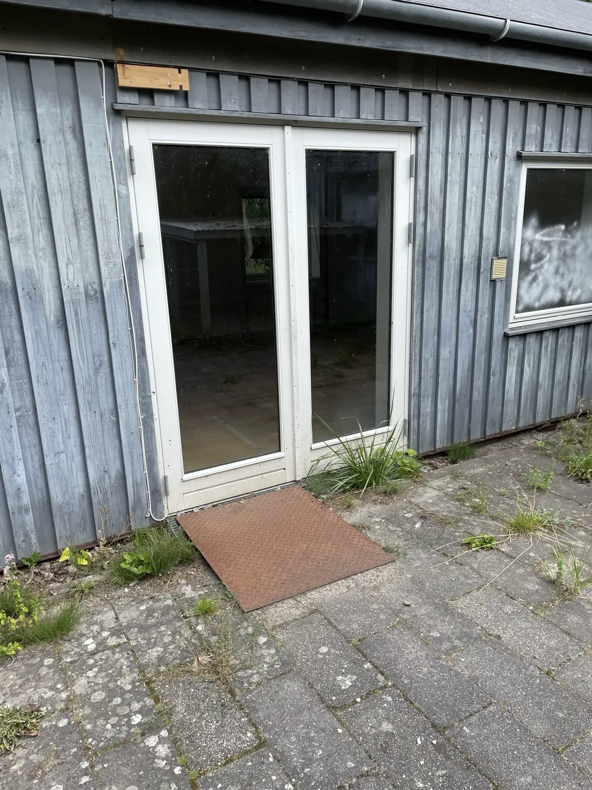 The double glazed door and vertical timber cladding in the courtyard
