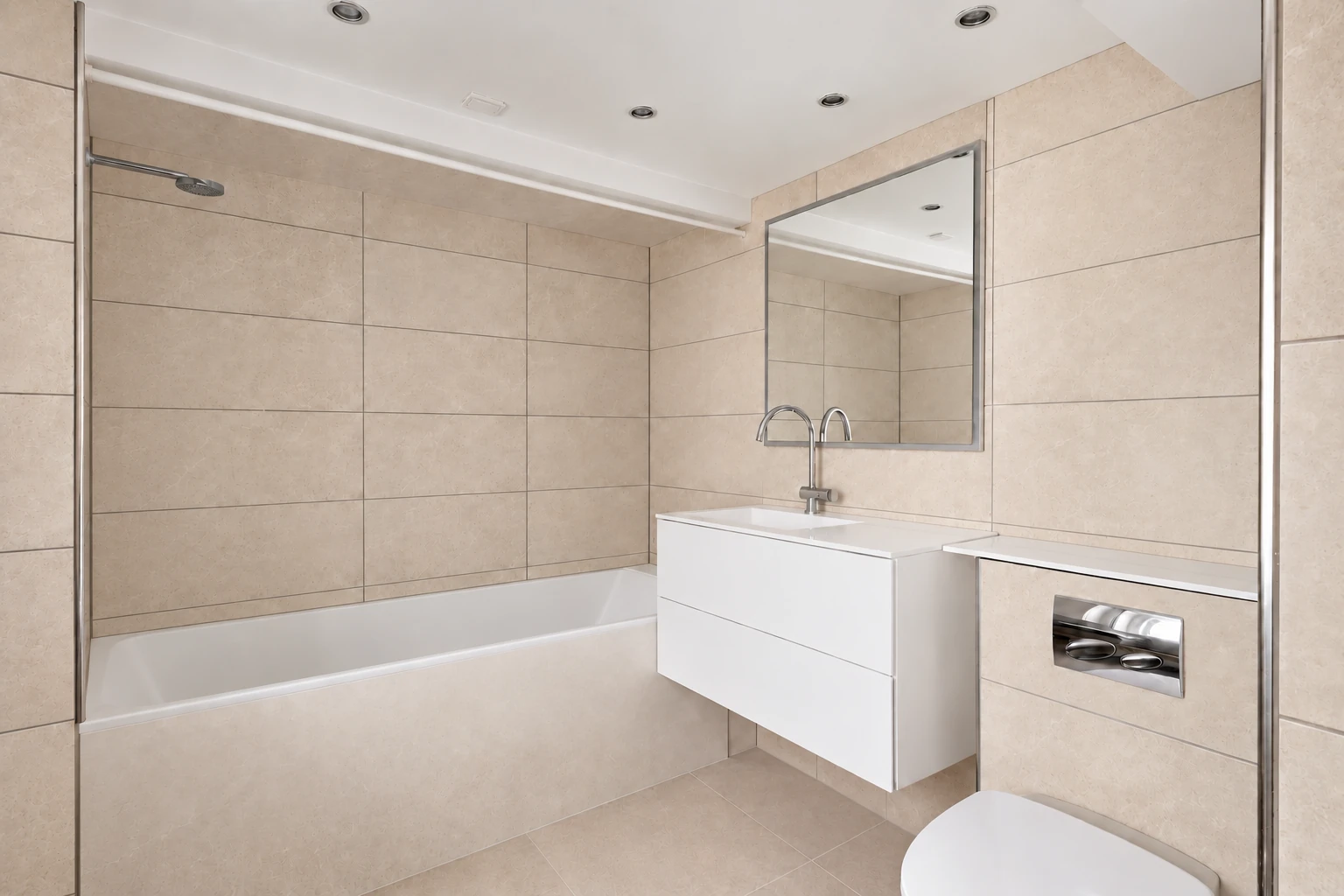 Warm limestone bathroom without towels or loose accessories